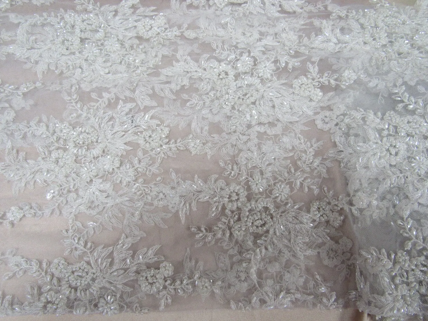 Gorgeous white French design embroider and beaded on a mesh lace. Wedding/Bridal/Prom/Nightgown fabric.